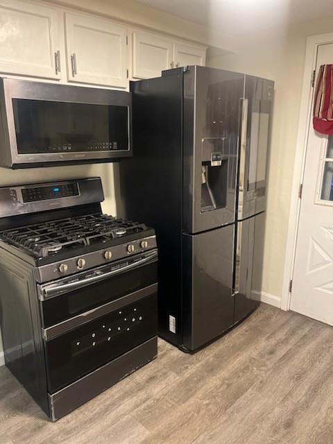 3887 Delco Road Brentwood, PA 15227 - Photo 8 of 14 a kitchen with granite countertop a refrigerator and a stove top oven