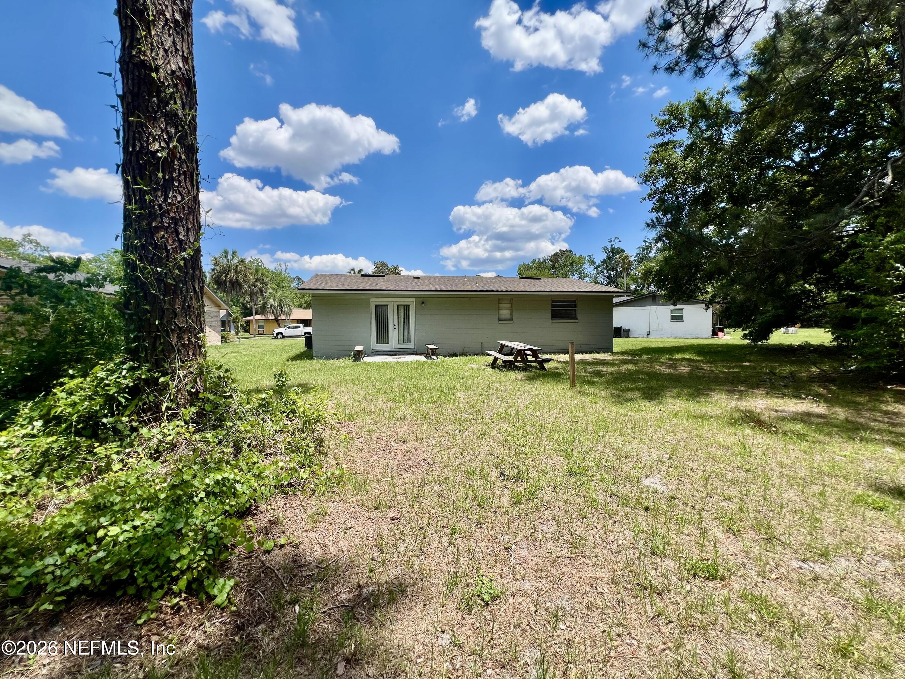 10964 Bacall Road West Jacksonville, FL 32218 - Photo 16 of 19 a view of a house with a big yard
