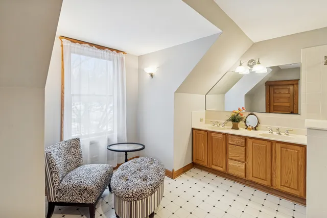 a bathroom with a granite countertop sink a toilet and a mirror