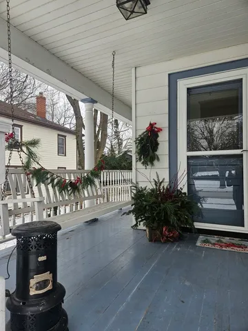 a view of a porch with furniture and garden