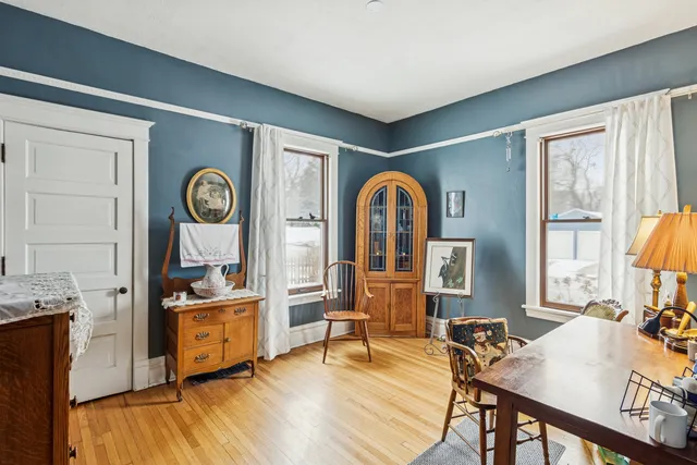 a view of a workspace with furniture and a window