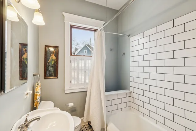 a bathroom with a bathtub and window