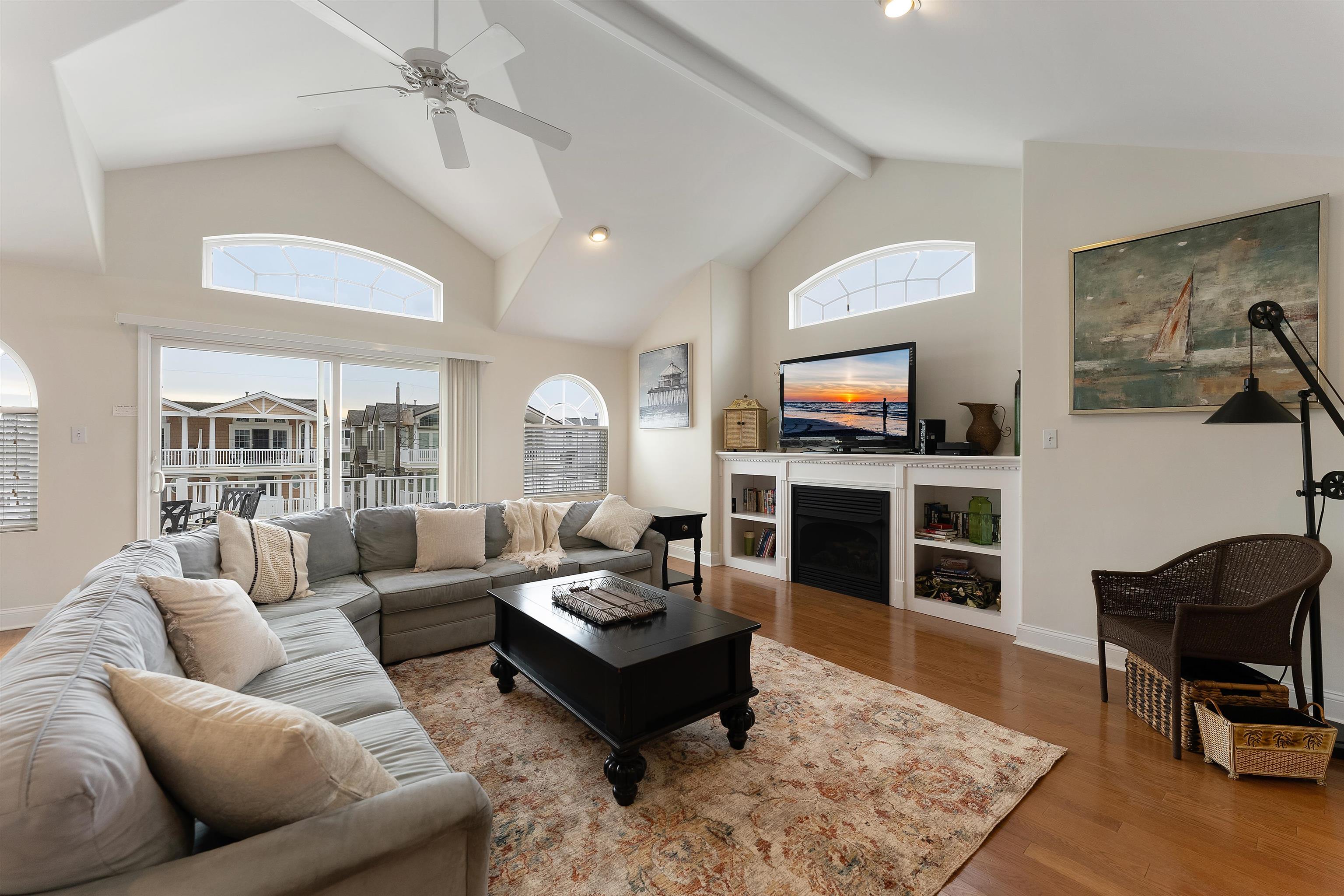 33 74th Street, Unit WEST Sea Isle City, NJ 08243 - Photo 11 of 48 a living room with furniture and a flat screen tv