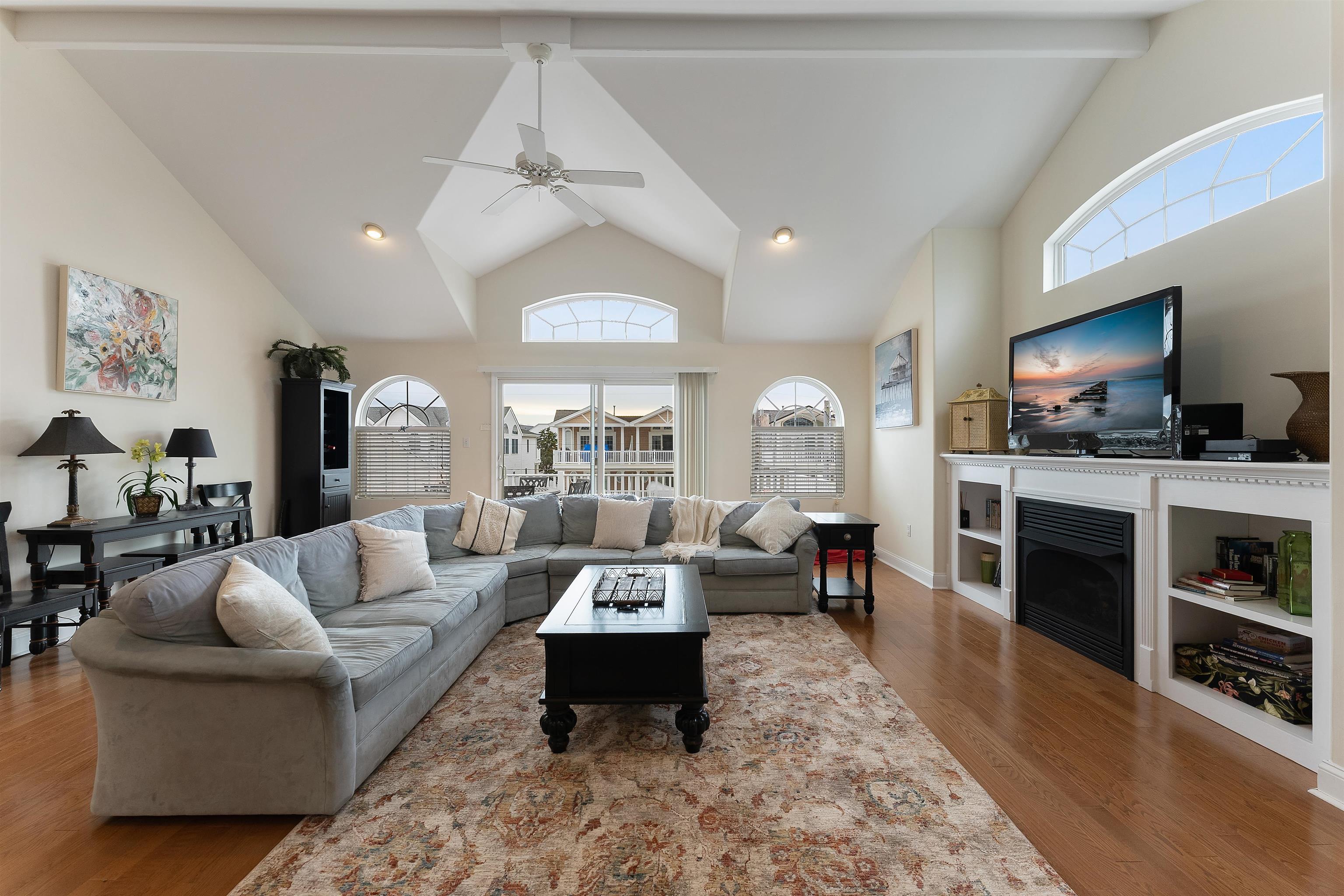 33 74th Street, Unit WEST Sea Isle City, NJ 08243 - Photo 12 of 48 a living room with fireplace furniture and a flat screen tv