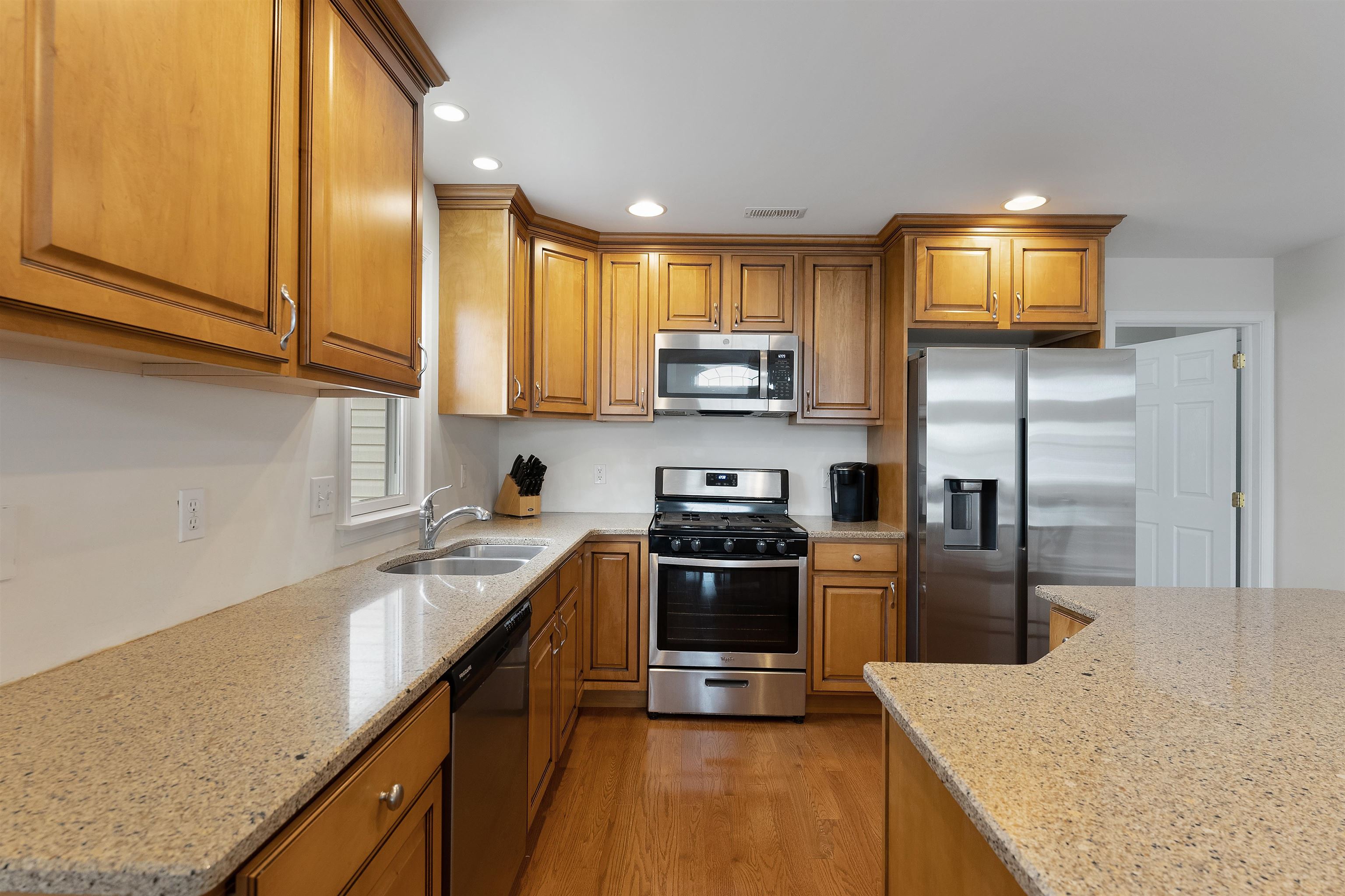 33 74th Street, Unit WEST Sea Isle City, NJ 08243 - Photo 16 of 48 a kitchen with stainless steel appliances granite countertop a refrigerator a stove top oven a sink and dishwasher