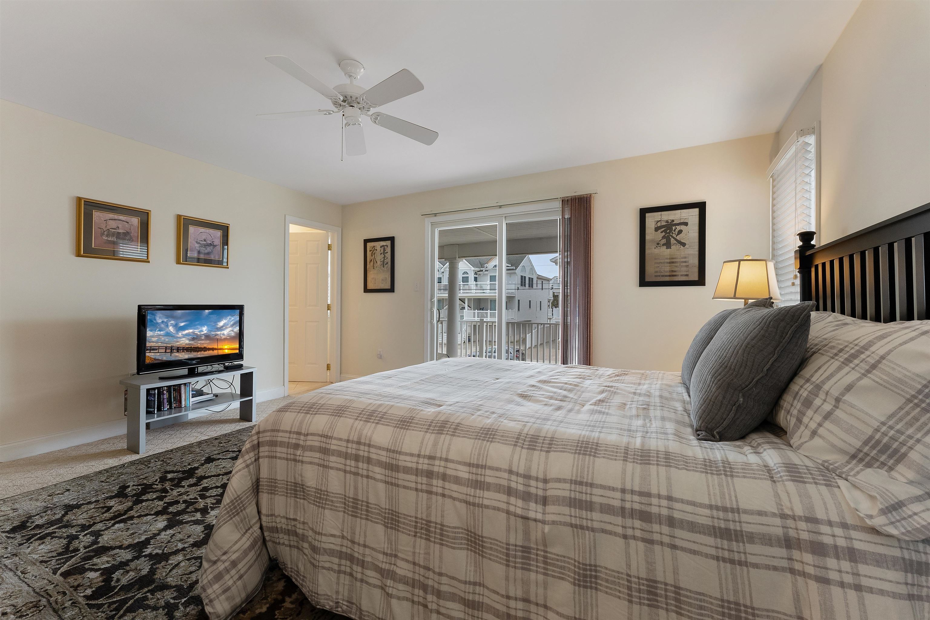 33 74th Street, Unit WEST Sea Isle City, NJ 08243 - Photo 29 of 48 a bedroom with a bed and dresser with mirror