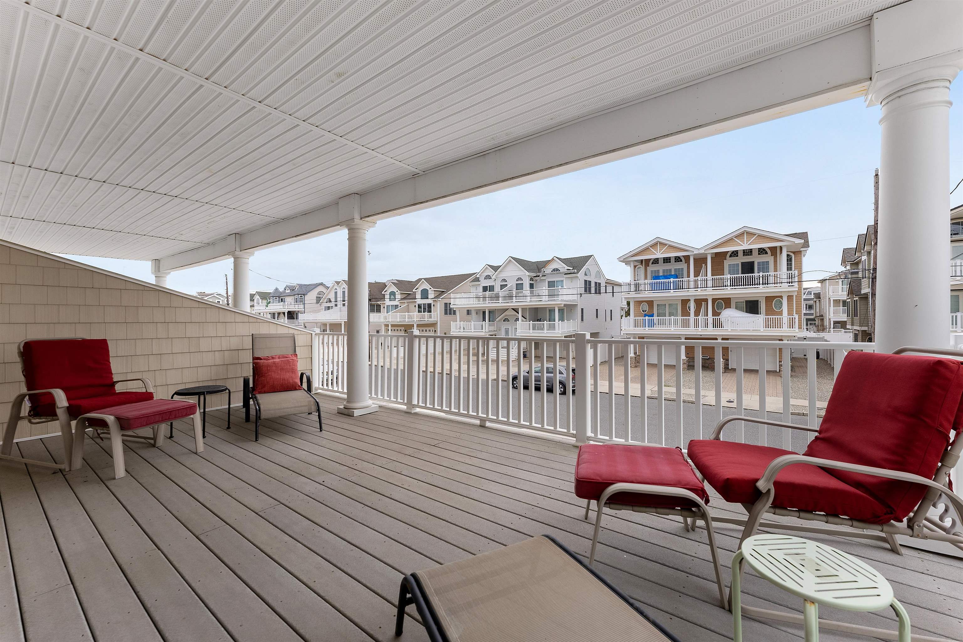 33 74th Street, Unit WEST Sea Isle City, NJ 08243 - Photo 31 of 48 a balcony with wooden floor table and chairs