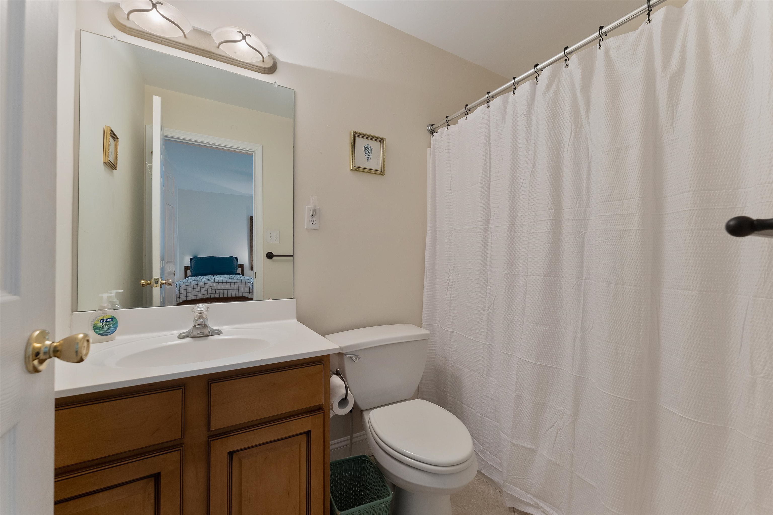 33 74th Street, Unit WEST Sea Isle City, NJ 08243 - Photo 33 of 48 a bathroom with a sink a toilet and shower curtain