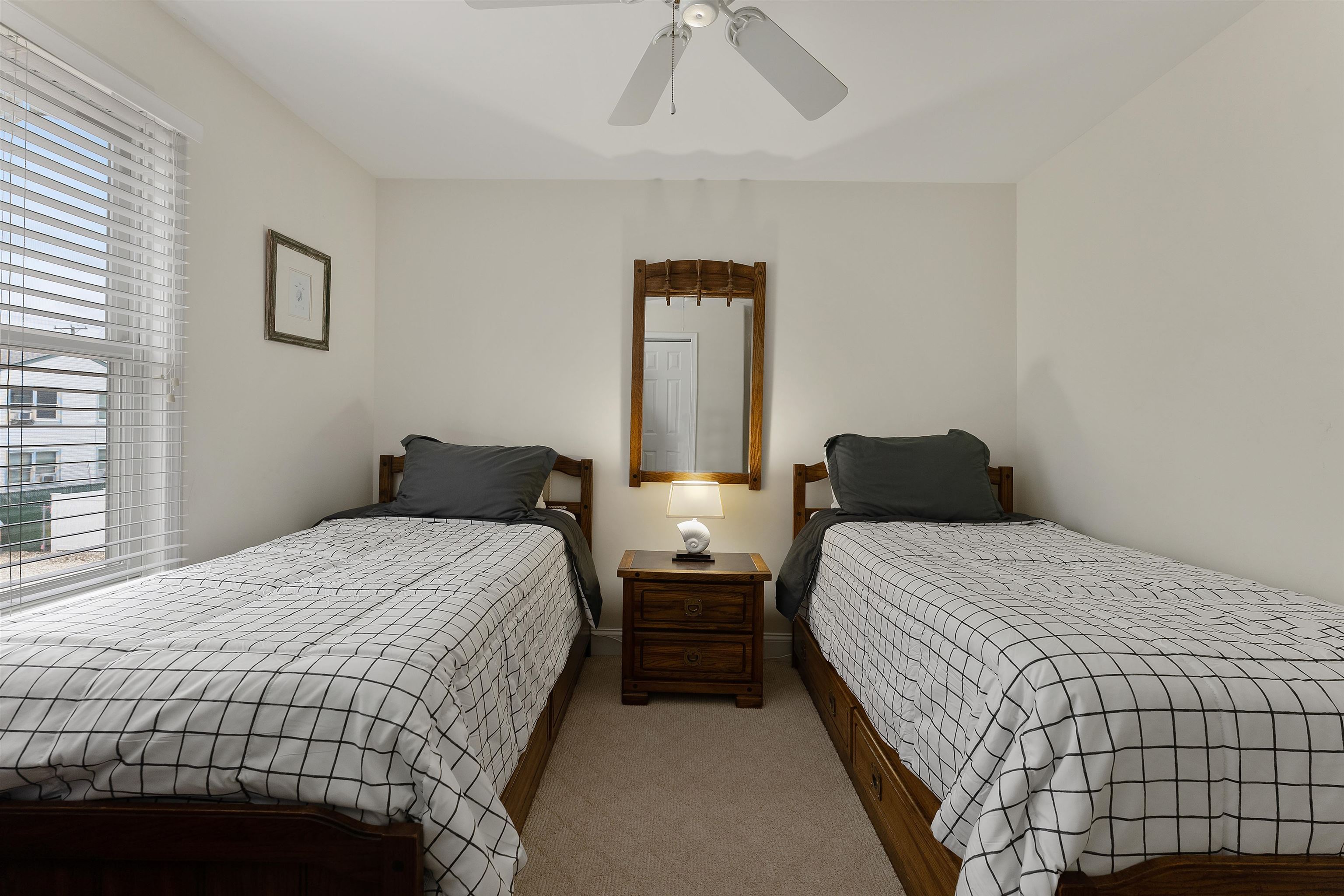 33 74th Street, Unit WEST Sea Isle City, NJ 08243 - Photo 34 of 48 a bedroom with double bed and a window