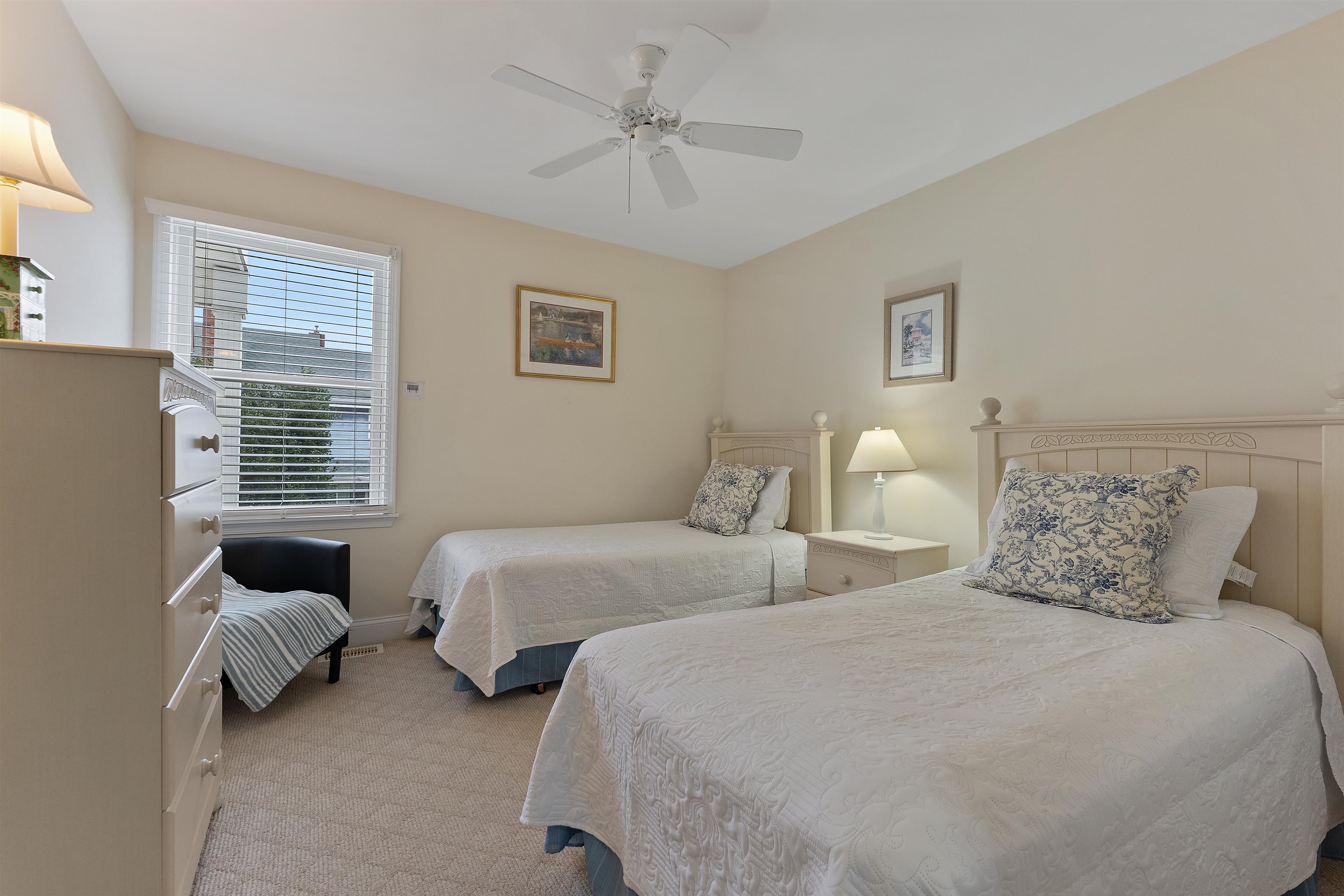 33 74th Street, Unit WEST Sea Isle City, NJ 08243 - Photo 35 of 48 a bedroom with two beds and a chandelier