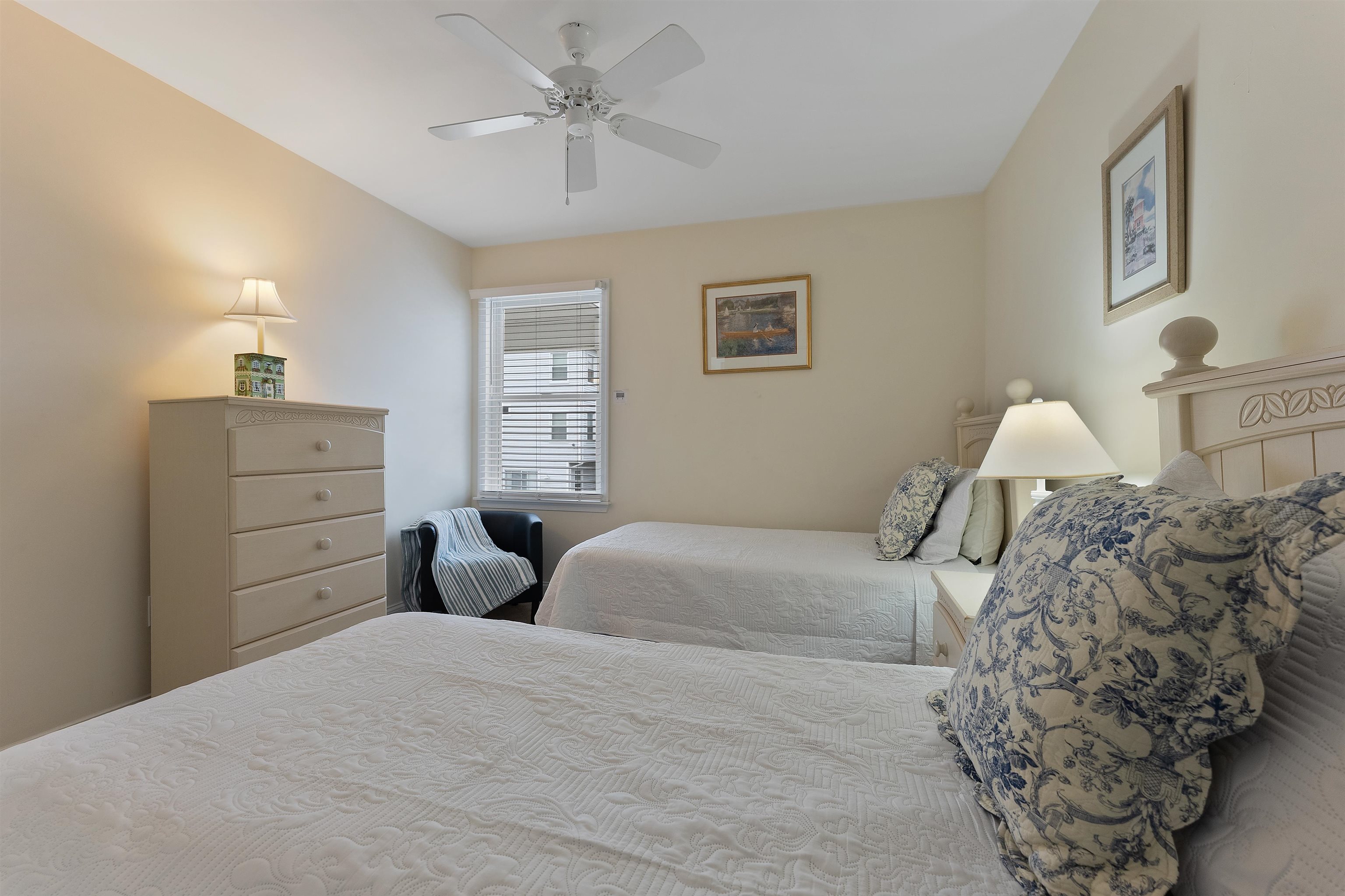 33 74th Street, Unit WEST Sea Isle City, NJ 08243 - Photo 36 of 48 a bedroom with a bed and a chandelier