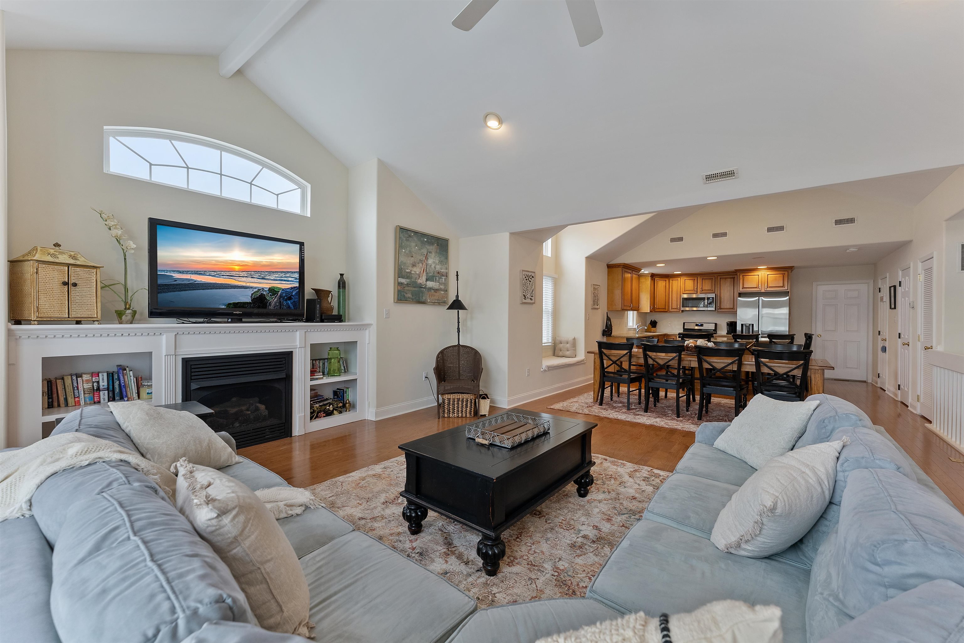 33 74th Street, Unit WEST Sea Isle City, NJ 08243 - Photo 4 of 48 a living room with furniture a fireplace and a flat screen tv