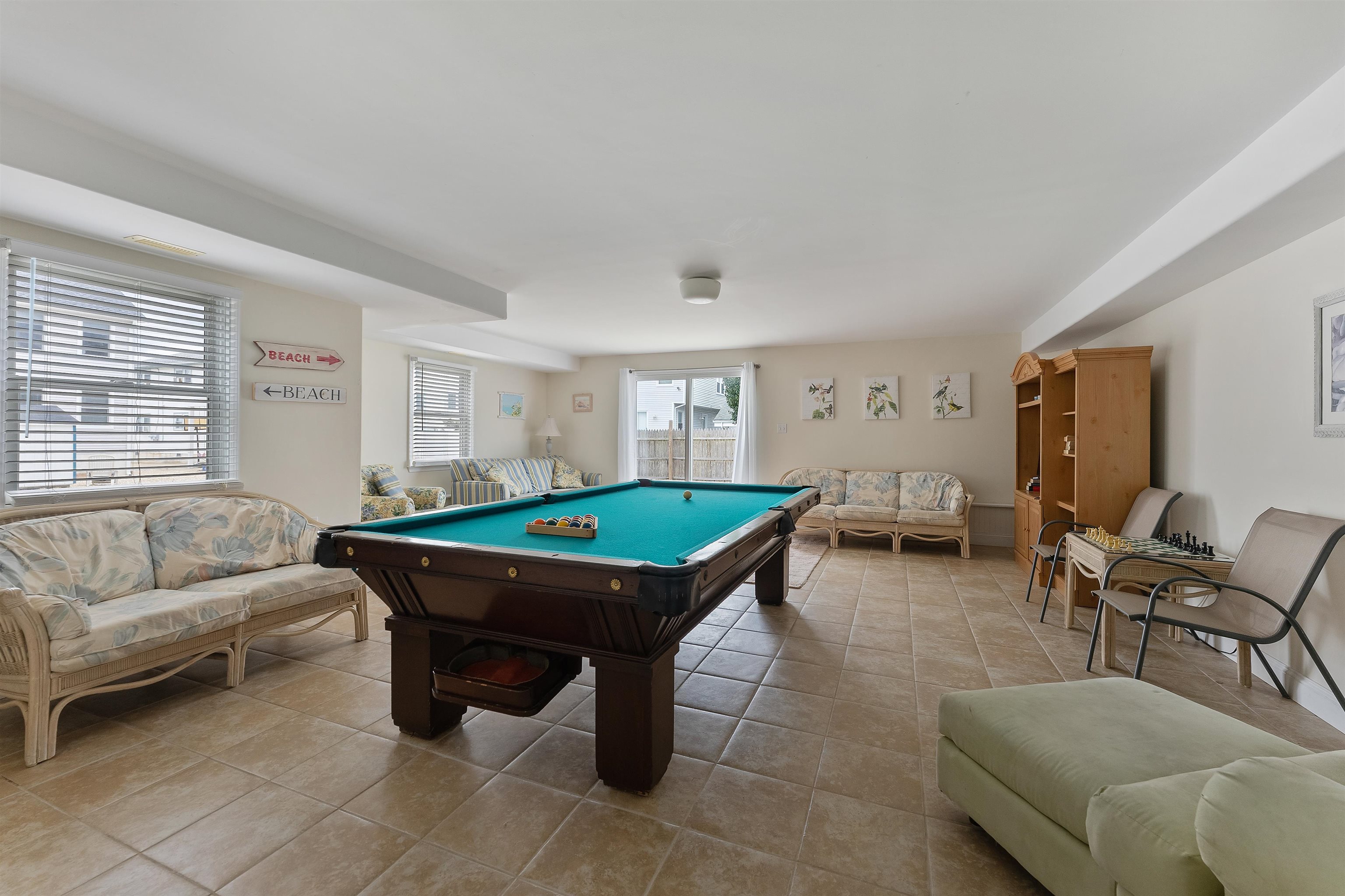 33 74th Street, Unit WEST Sea Isle City, NJ 08243 - Photo 42 of 48 a living room with furniture a table and a window