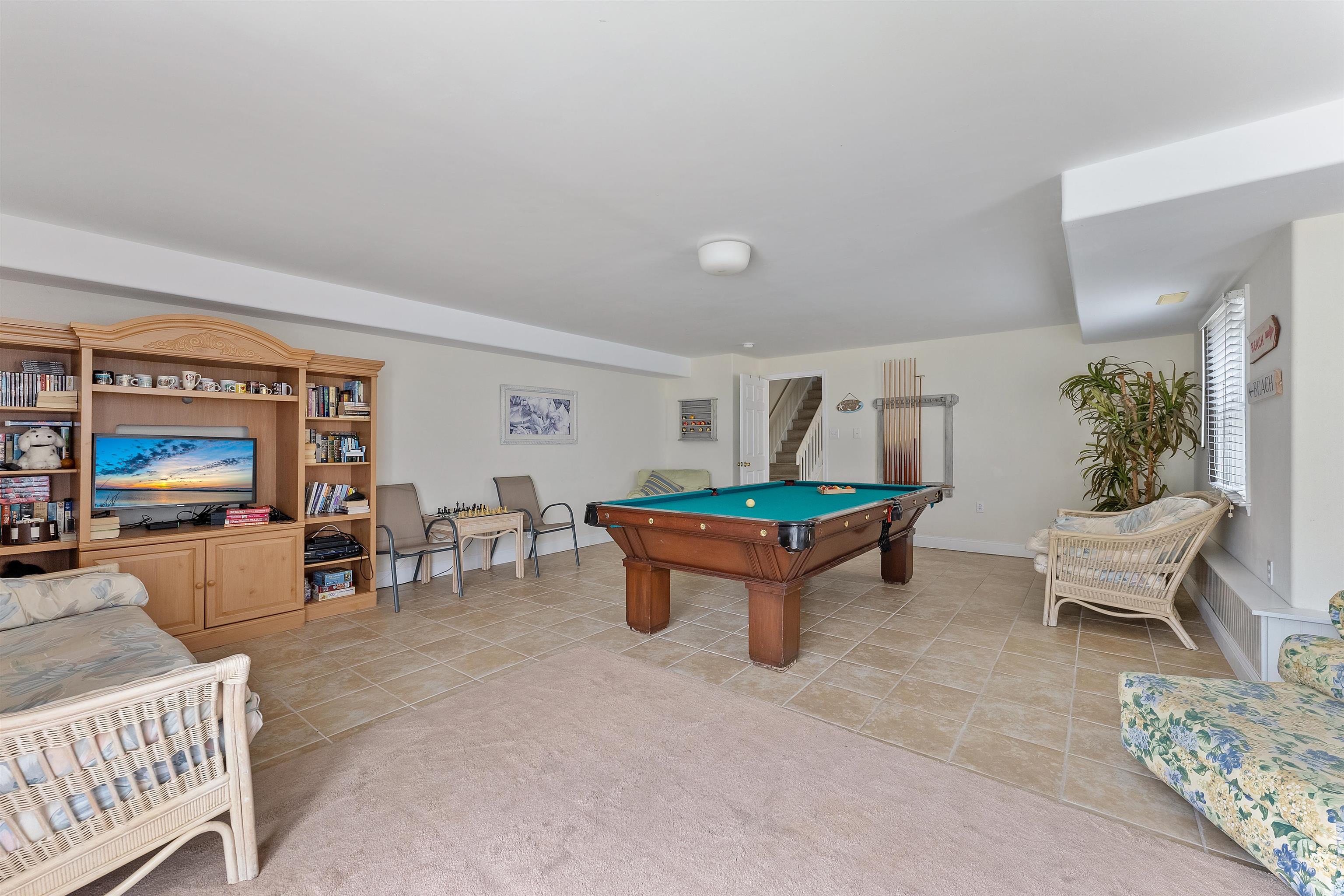33 74th Street, Unit WEST Sea Isle City, NJ 08243 - Photo 44 of 48 a living room with furniture and a flat screen tv