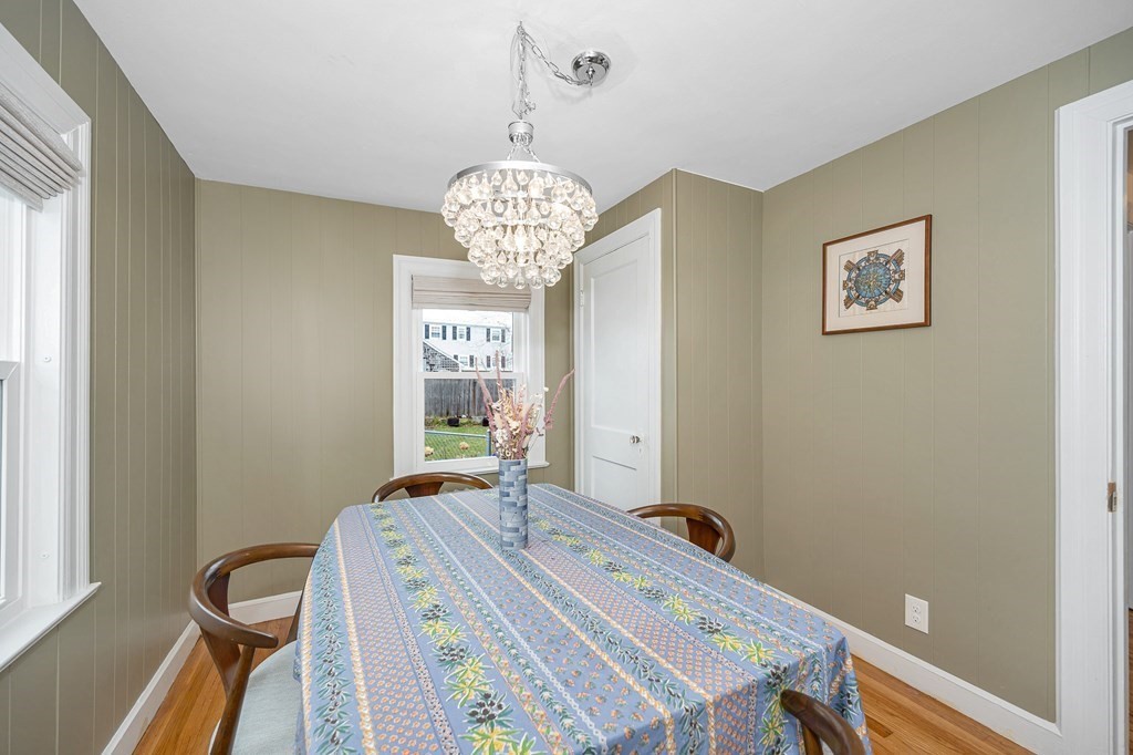 19 Curtis Road Saugus, MA 01906 - Photo 13 of 36 a bedroom with a bed and a chandelier