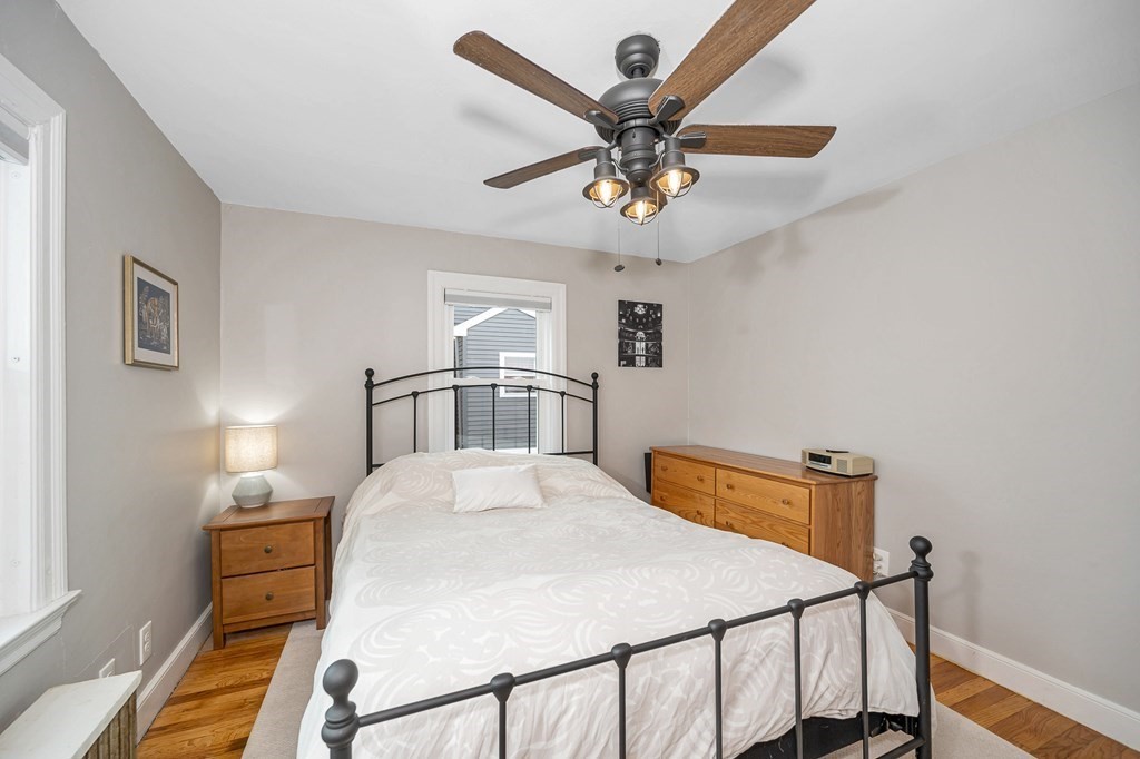 19 Curtis Road Saugus, MA 01906 - Photo 15 of 36 a bedroom with a bed and a chandelier