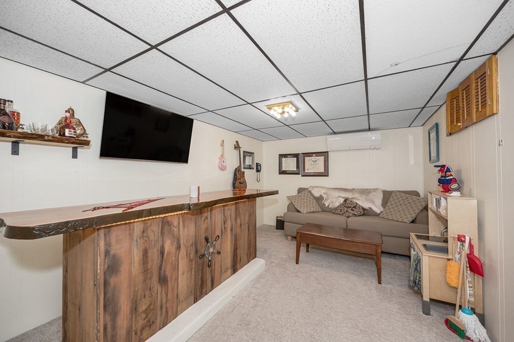 19 Curtis Road Saugus, MA 01906 - Photo 21 of 36 a living room with furniture and a flat screen tv