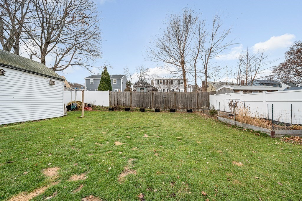 19 Curtis Road Saugus, MA 01906 - Photo 32 of 36 a backyard of a house with table and chairs