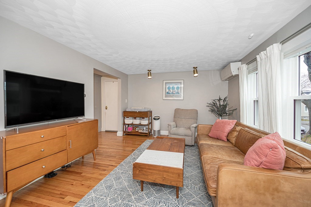 19 Curtis Road Saugus, MA 01906 - Photo 5 of 36 a living room with furniture and a flat screen tv