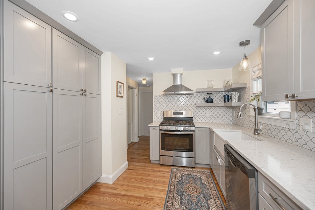 19 Curtis Road Saugus, MA 01906 - Photo 10 of 36 a kitchen with stainless steel appliances granite countertop a sink stove and refrigerator
