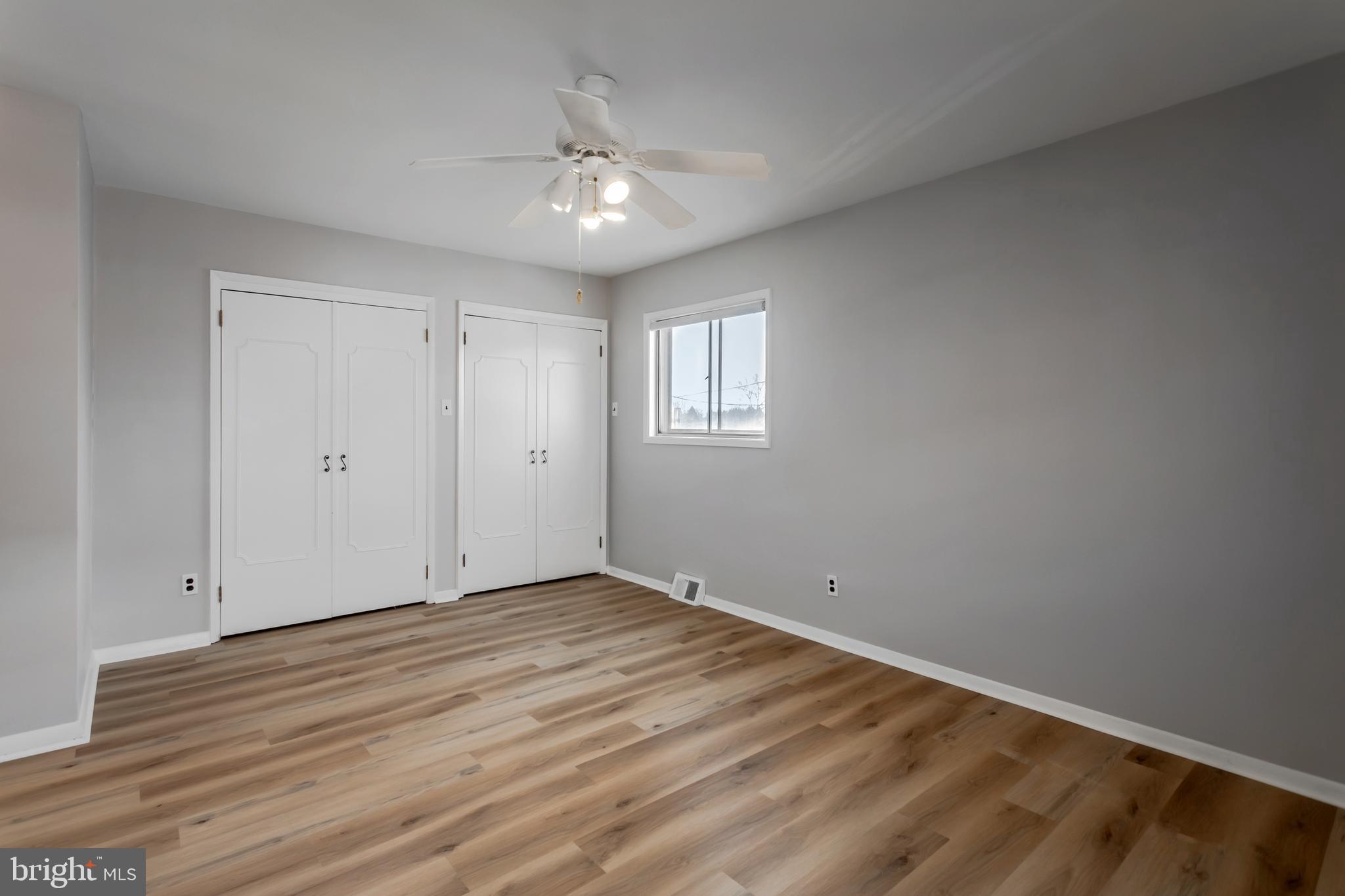 138 Juniper Road Havertown, PA 19083 - Photo 16 of 29 a view of an empty room with window and wooden floor