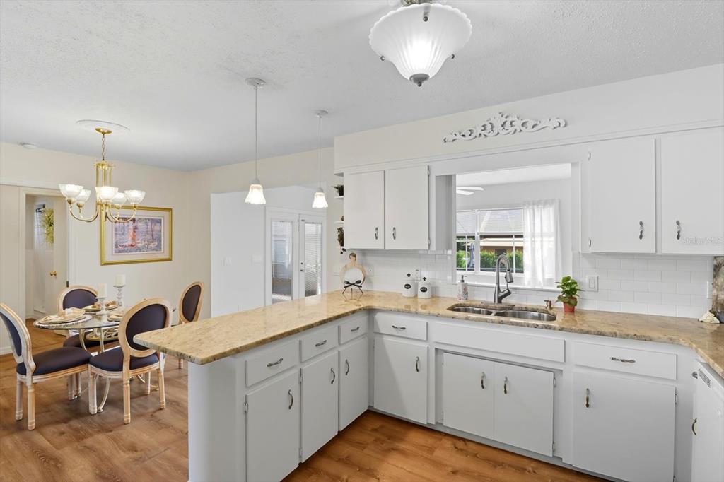 305 Edison Street Inverness, FL 34452 - Photo 13 of 44 a kitchen with a sink cabinets and window