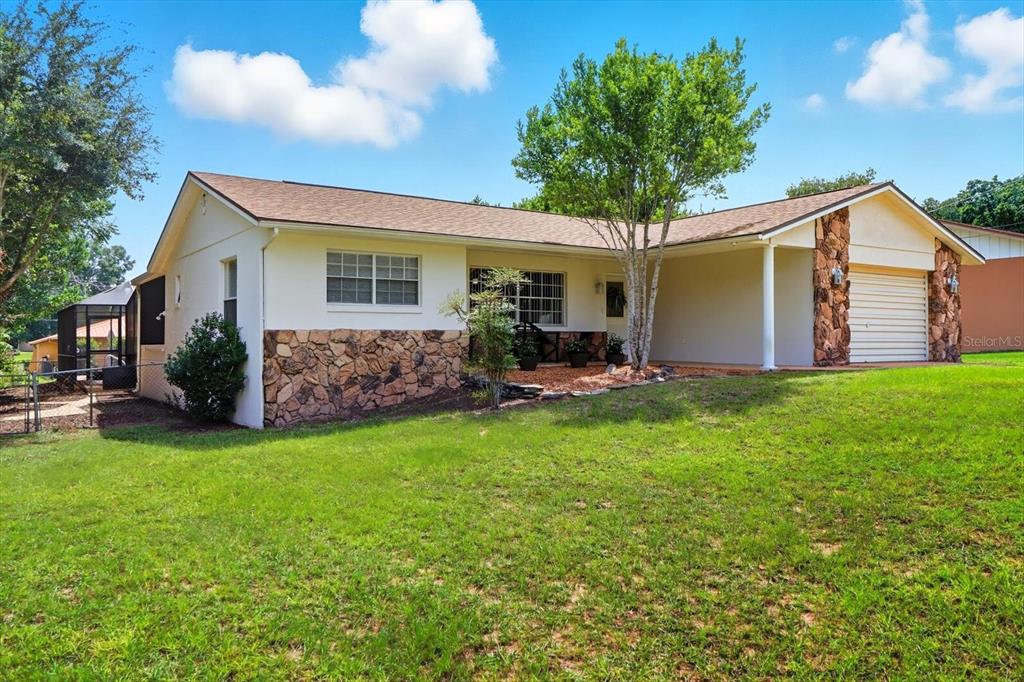 305 Edison Street Inverness, FL 34452 - Photo 2 of 44 a front view of house with yard and green space