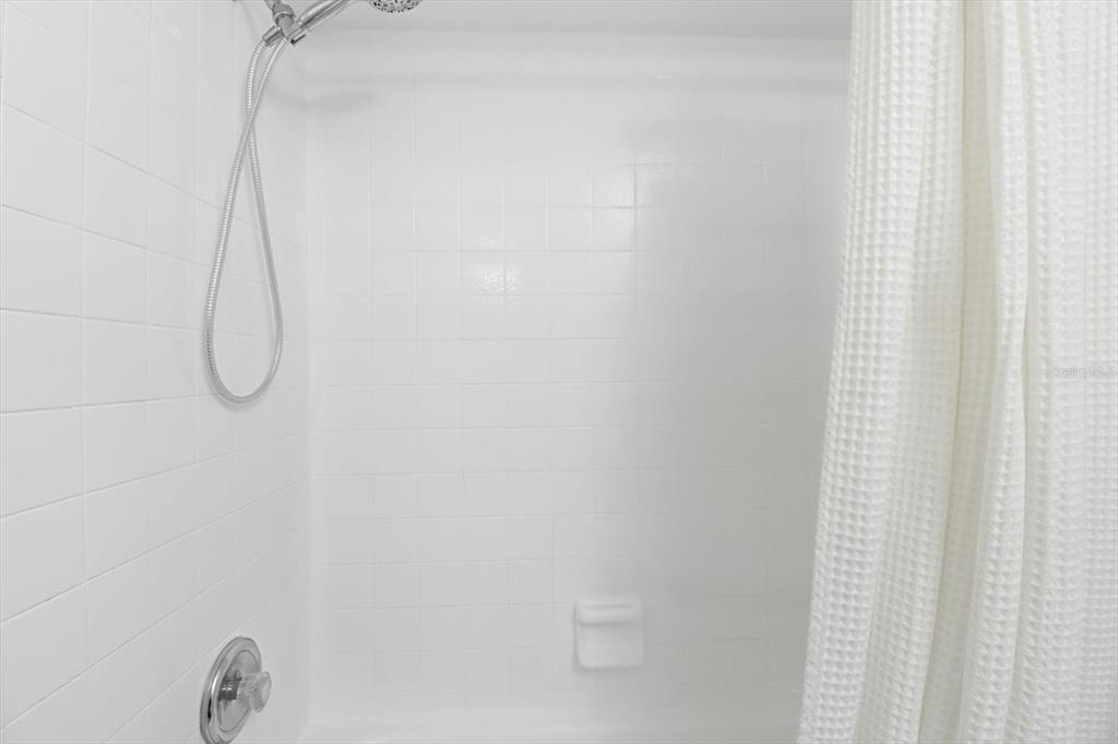 305 Edison Street Inverness, FL 34452 - Photo 28 of 44 a bathroom with a glass shower door