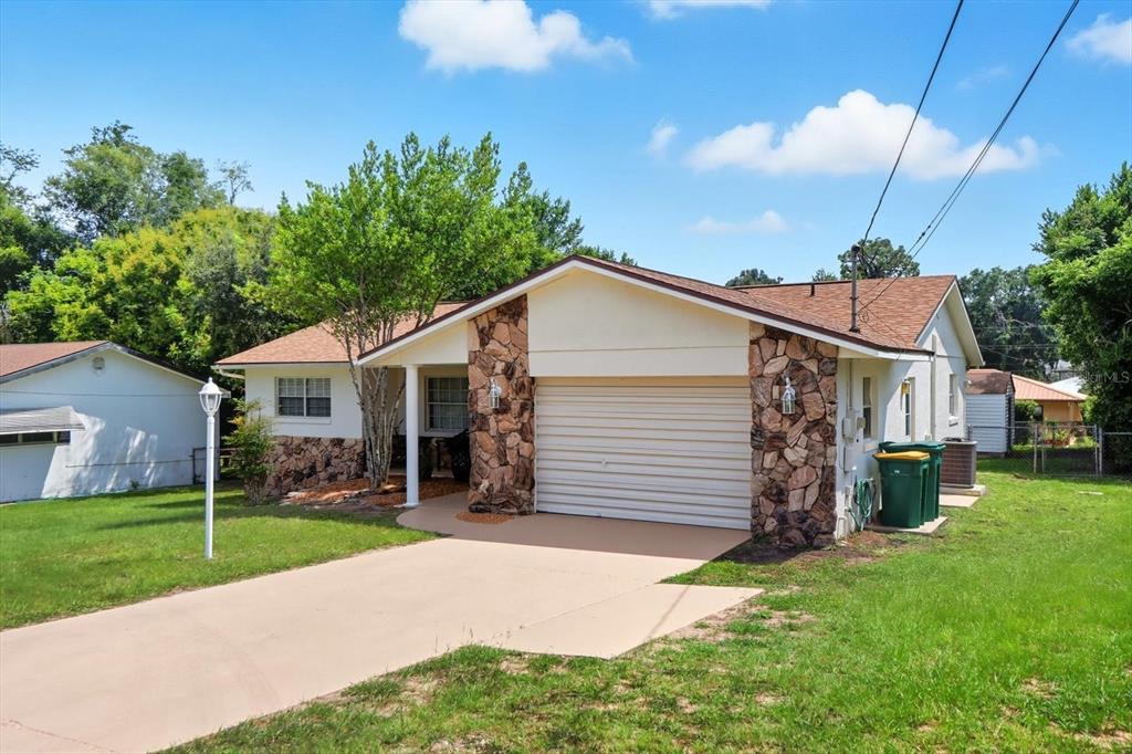 305 Edison Street Inverness, FL 34452 - Photo 3 of 44 a view of a house with a yard