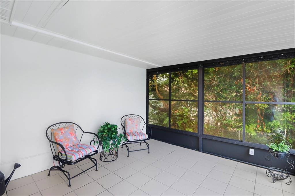 305 Edison Street Inverness, FL 34452 - Photo 31 of 44 a living room with furniture and a floor to ceiling window