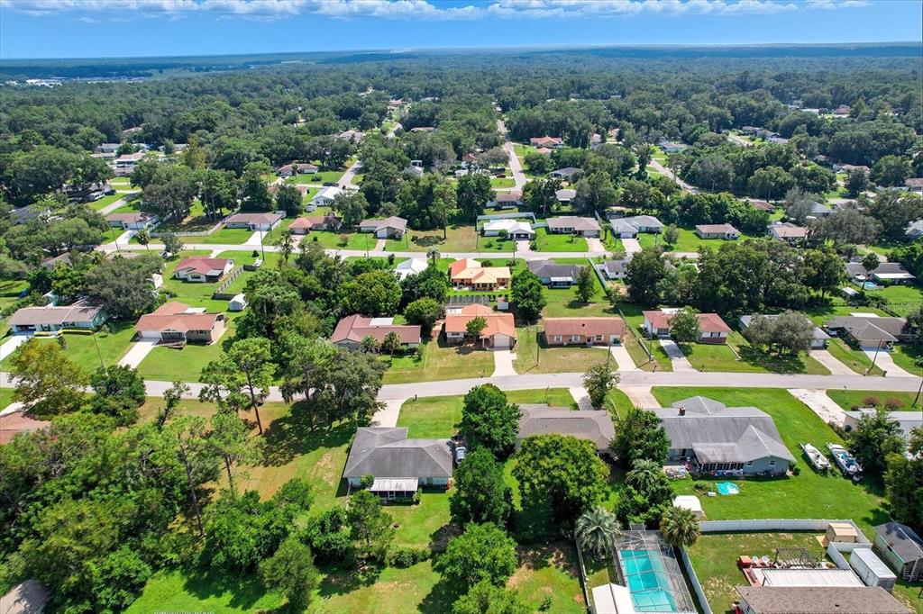 305 Edison Street Inverness, FL 34452 - Photo 42 of 44 an aerial view of a city with lots of residential buildings and mountain view in back