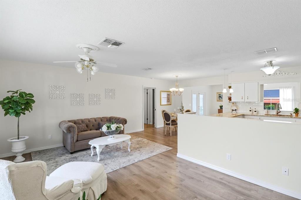 305 Edison Street Inverness, FL 34452 - Photo 8 of 44 a living room with furniture and a chandelier