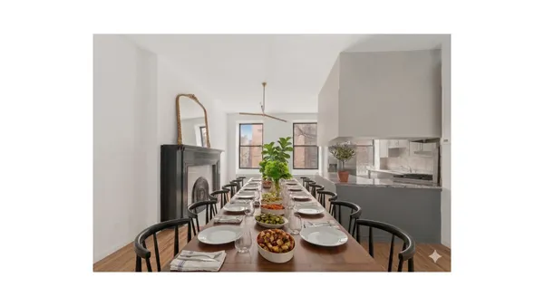 a view of a hallway with wooden floor and a fireplace