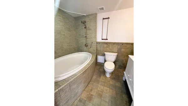 a living room with a bed furniture and a window