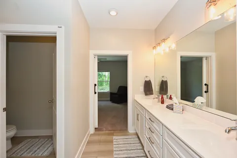 a bathroom with a double vanity sink and a mirror