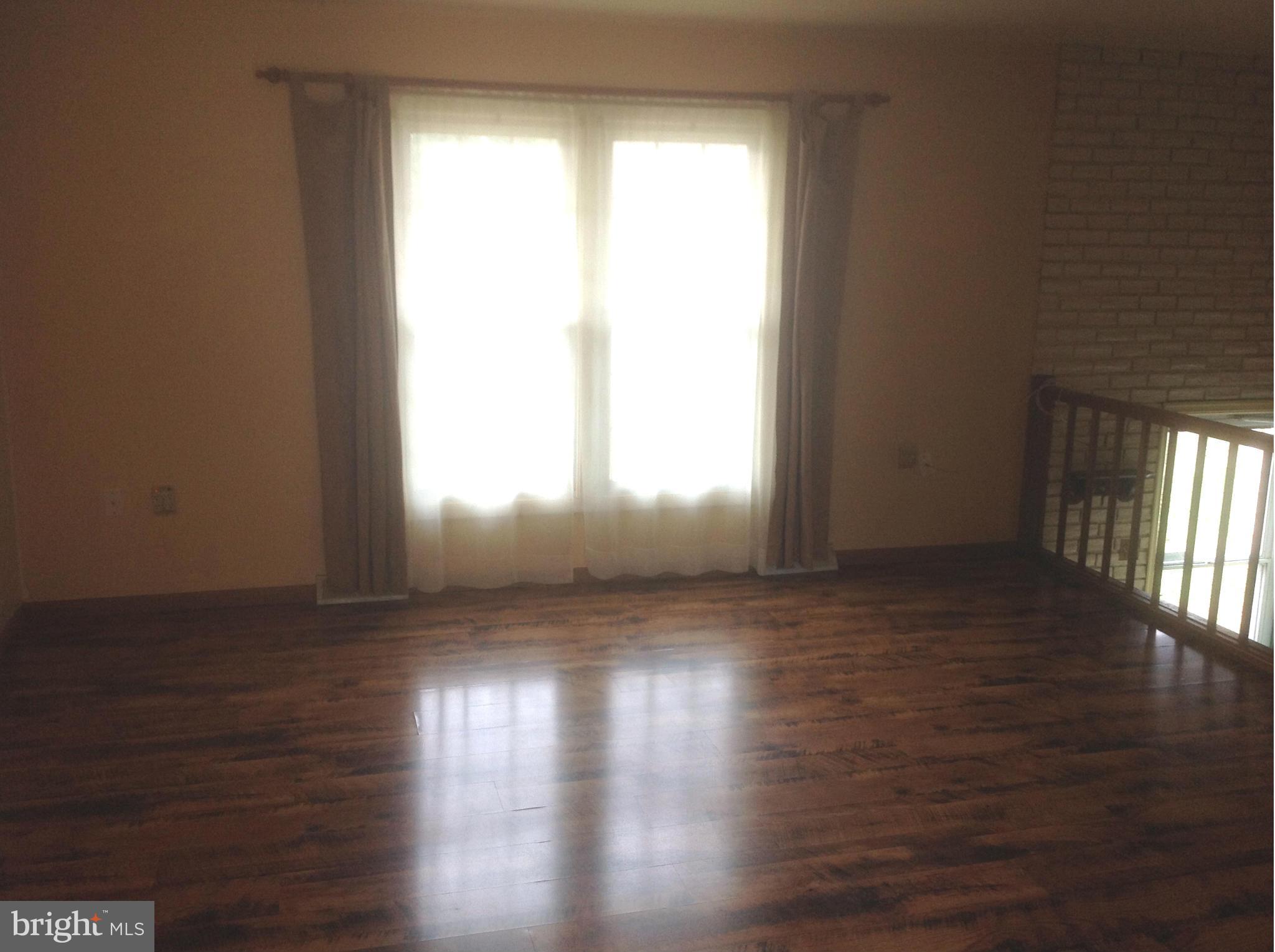 1640 Gibbons Road Point of Rocks, MD 21777 - Photo 7 of 20 a view of wooden floor and windows in an empty room