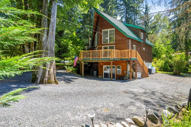 a view of a house with backyard and sitting area