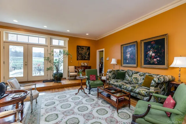 a living room with furniture and a floor to ceiling window