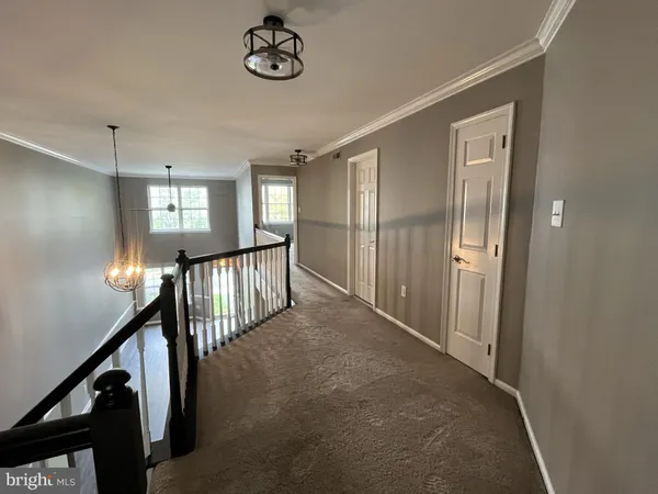 a view of a hallway with windows and stairs