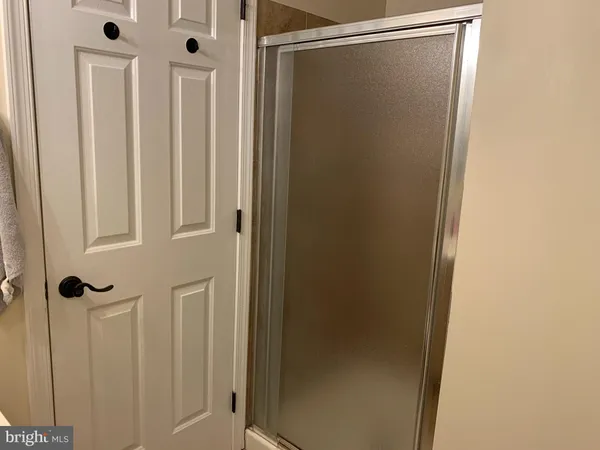 a bathroom with a glass shower door