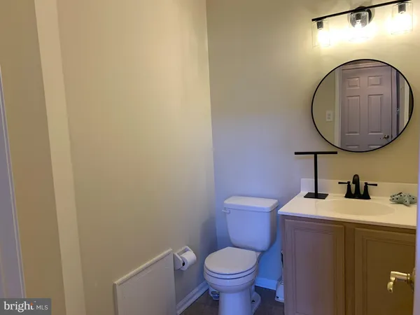 a bathroom with a toilet a sink and a mirror