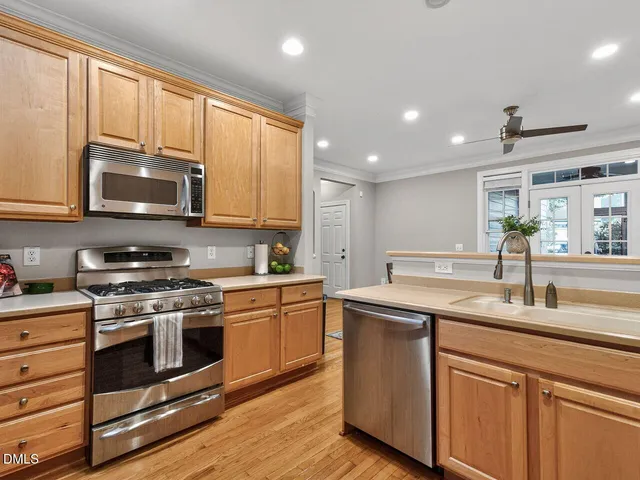 a kitchen with a sink window and cabinets