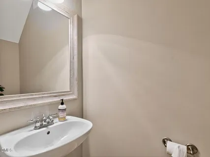 a kitchen with stainless steel appliances granite countertop wooden cabinets a sink a stove a dining table and chairs