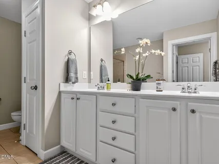 a spacious bedroom with a bed and a large window