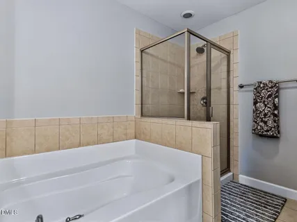 a bedroom with a bed and lamp