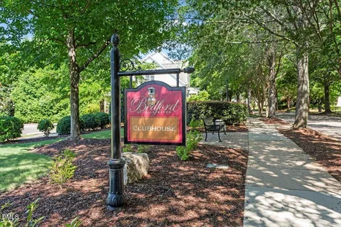 a view of a yard with a house in the background