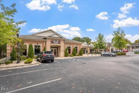 a front view of a house with yard and green space