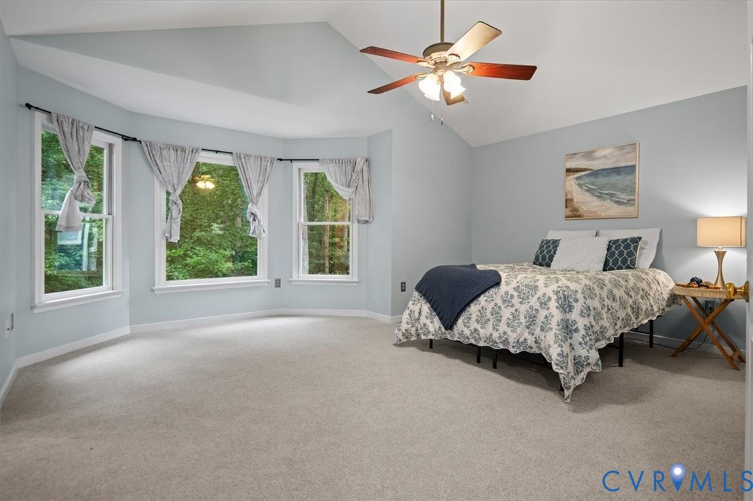 5506 Windy Ridge Terrace Midlothian, VA 23112 - Photo 27 of 50 a bedroom with a large bed and a chandelier