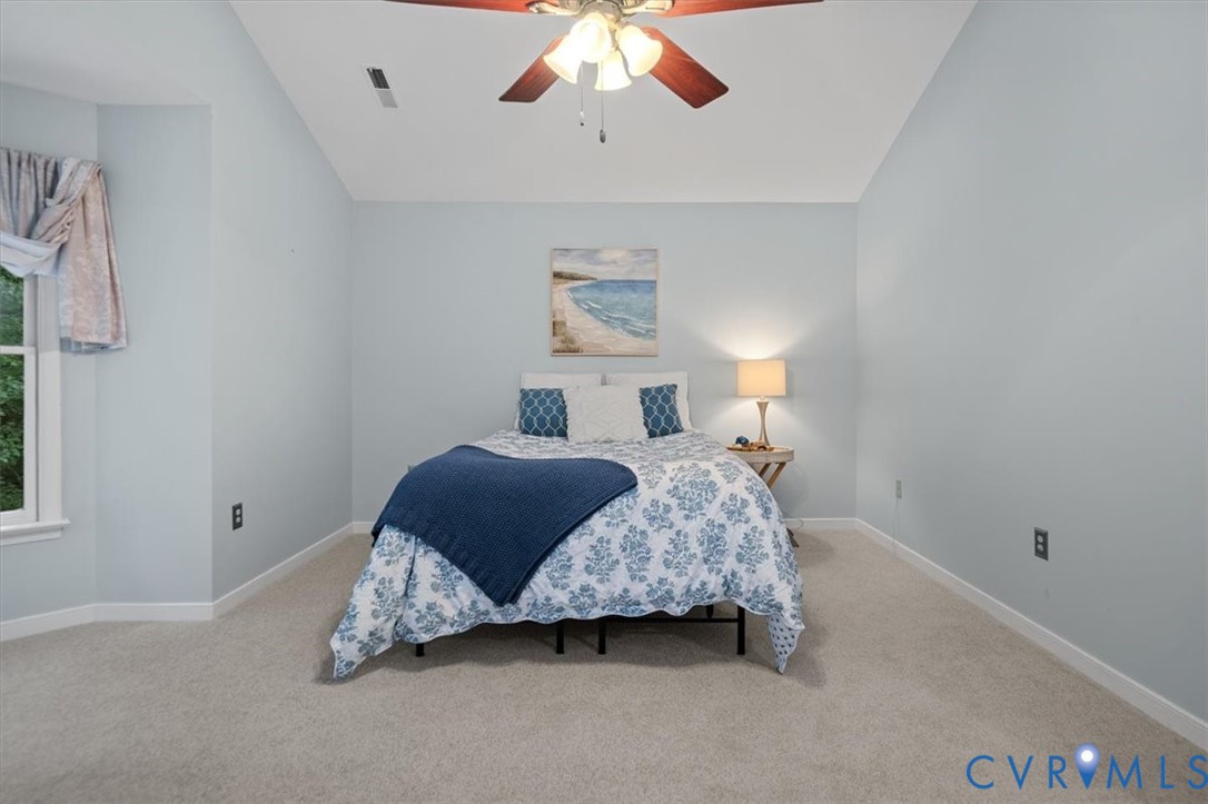 5506 Windy Ridge Terrace Midlothian, VA 23112 - Photo 28 of 50 a bedroom with a bed and a chandelier