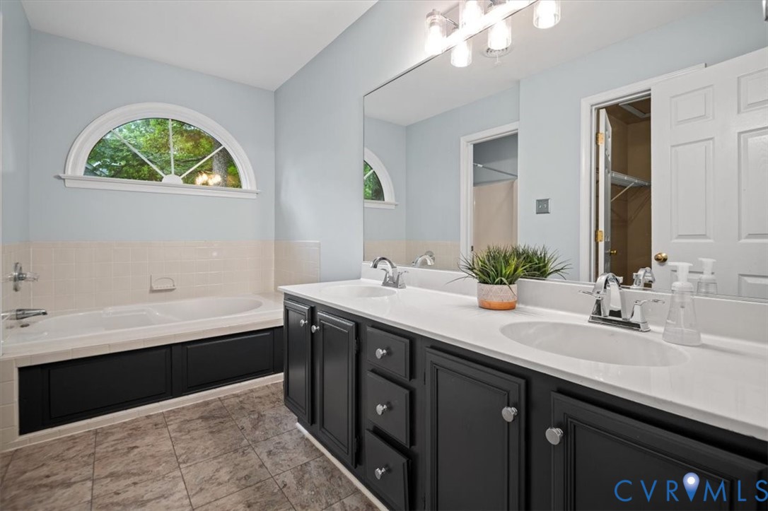 5506 Windy Ridge Terrace Midlothian, VA 23112 - Photo 30 of 50 a bathroom with a tub double vanity sink and a large mirror